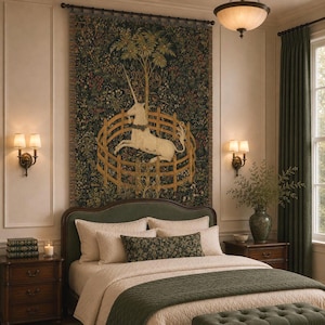 May include: A large rectangular wall tapestry featuring a white unicorn enclosed within a wooden fence, set against a dark green floral background. The woven textile displays intricate botanical details and is suspended from a black metal rod.