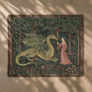 May include: A woven tapestry throw blanket featuring a large green dragon and a person in a long pink dress standing in a dense forest. The scene is surrounded by dark green trees, foliage, and small flowers, finished with a fringed edge border.