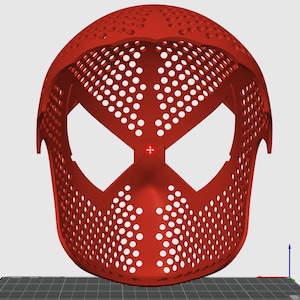May include: A red, 3D-printed mask with a distinctive design featuring large eye openings and a perforated surface. The mask's shape is reminiscent of a superhero's mask, with a smooth, curved top and a defined facial structure.