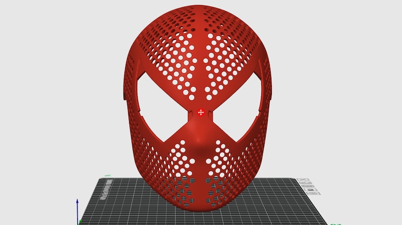 May include: A red, perforated mask with large eye openings and a distinctive design. The mask is likely for cosplay or costume use, and is made of a solid material. The mask is displayed on a black and grey surface.