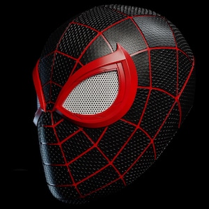 May include: Black and red Spider-Man mask with a textured surface and a web pattern. The mask features red eye frames with white mesh eye coverings. The mask is set against a black background.