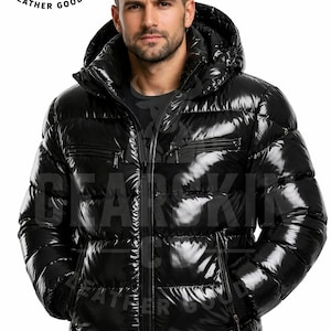May include: A glossy black puffer jacket with a hood and multiple zippered pockets. The jacket has a shiny, reflective finish and a full-length zipper. The brand name "GEARSKIN CO LEATHER GOODS" is visible in the upper left corner.