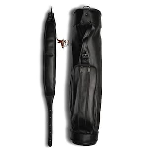 May include: Black leather golf bag with a matching shoulder strap. The bag has a cylindrical shape with a zippered pocket on the front. The shoulder strap is long and padded for comfort. The bag is designed to carry golf clubs.