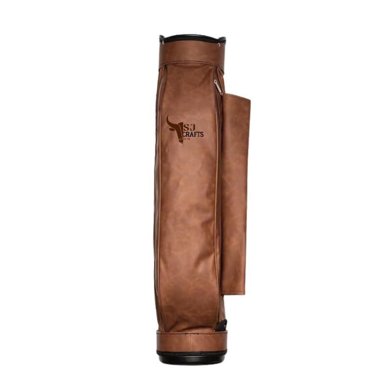 May include: A brown leather golf bag with a side pocket and a black base. The bag has a zipper and the text "S.J. Crafts" with a bull logo. The bag is designed to hold golf clubs.
