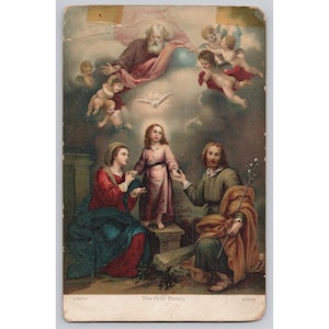 May include: Vintage religious print depicting the Holy Family. The image shows Mary, Joseph, and Jesus, with God and angels above. The print has a faded appearance, with the text "The Holy Family" at the bottom. The print is rectangular and has a distressed look.