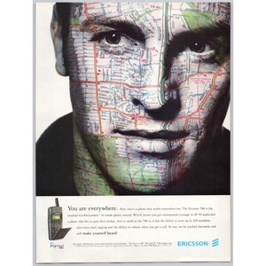 May include: An advertisement featuring a man's face overlaid with a map design. The text "You are everywhere" is displayed, along with an image of a small mobile phone. The Ericsson logo is visible.