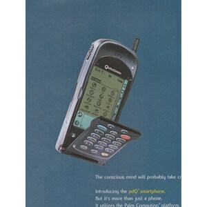 May include: A dark gray Qualcomm pdQ smartphone with a flip-down keypad cover. The screen displays a grid of icons and the text Qualcomm. Below the device, text reads: The conscious mind will probably take cr, Introducing the pdQ smartphone, But it's more than just a phone, It utilizes the Palm Computing platform.