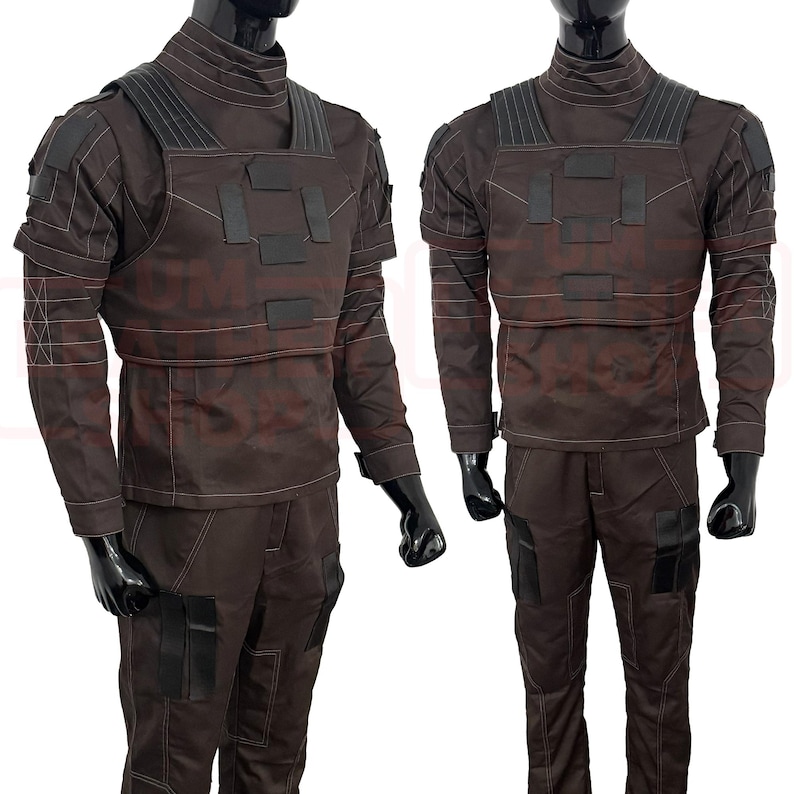 May include: Two brown tactical outfits displayed on mannequins. Each outfit includes a long-sleeved shirt, pants, and a chest rig with black accents. The outfits have a high collar and multiple pockets.