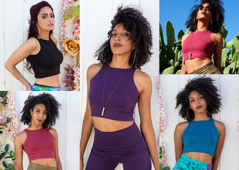 May include: Five women wearing different colored crop tops. The tops are sleeveless and have a high neckline. The women are wearing different colored pants and skirts.