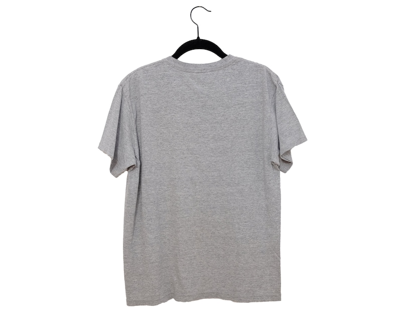 May include: A plain gray t-shirt hanging on a black hanger against a white background.