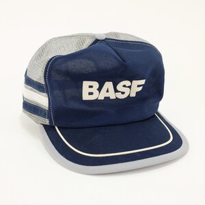 May include: A blue and gray mesh trucker hat with a white "BASF" logo.