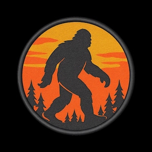 May include: Circular graphic featuring a black silhouette of Bigfoot walking, set against an orange and yellow sunset. The design includes dark green pine trees at the bottom, all within a black border. The overall theme is nature and the outdoors.