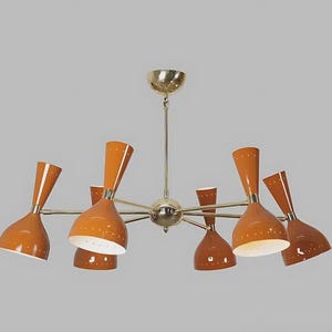 May include: A mid-century modern chandelier with eight orange cone-shaped shades. The light fixture has a brass finish and is suspended from a central point. The shades have white interiors and small decorative holes.