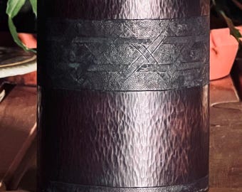 Copper vase with a subtle Celtic band design and hand hammered texture enhanced by a dark bronze patina.