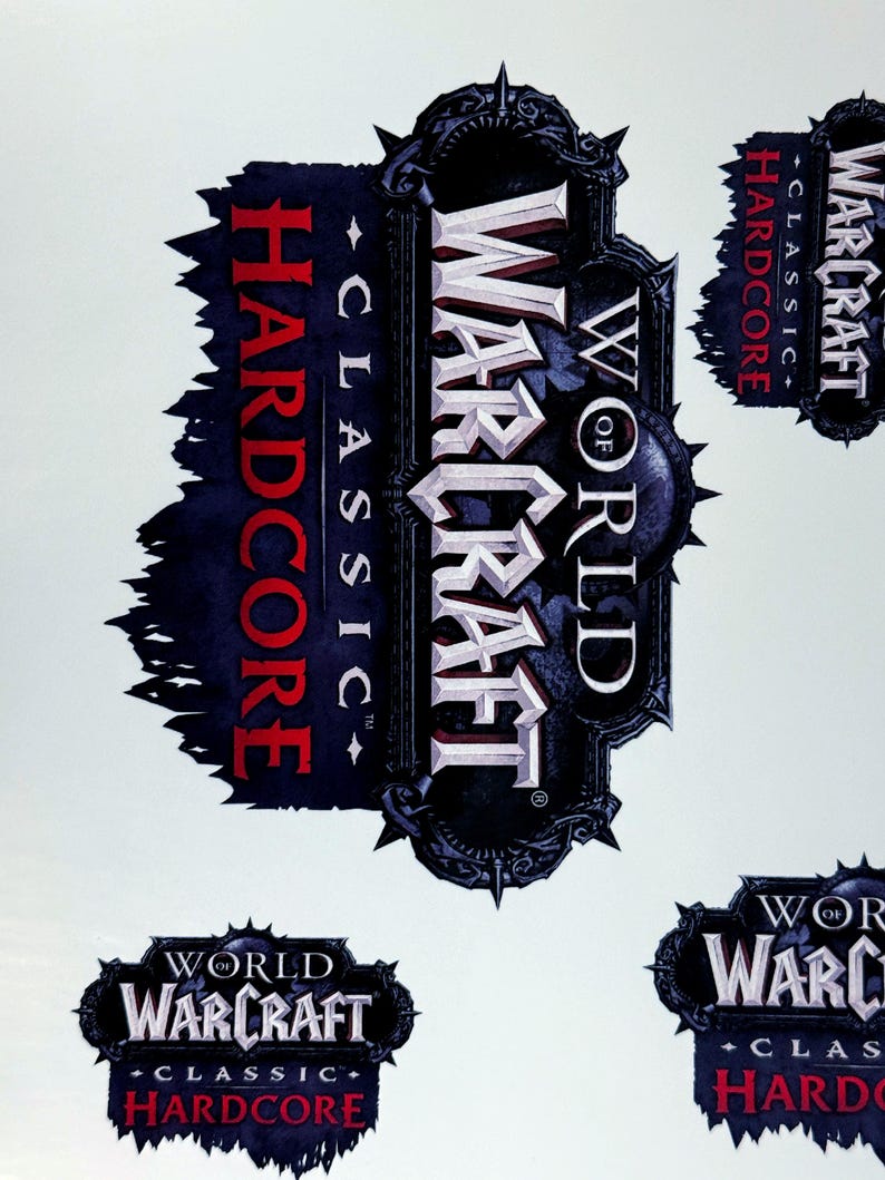 May include: Multiple stickers featuring the "World of Warcraft Classic Hardcore" logo. The main logo is a dark gray emblem with the game title in white and red text. The design includes spiky edges and a dark blue background.