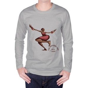 May include: A light gray long-sleeve shirt featuring a graphic of a woman in a red dress with arm bangles. The text "THE UNIVERSAL HUG WITH SAUDA" is printed below the graphic in a semi-circle.