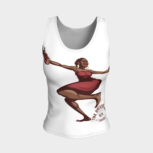 May include: White tank top featuring a cartoon illustration of a woman in a red dress dancing. The woman has dark skin and is wearing gold hoop earrings. Text on the bottom of the tank top reads "THE UNIVERSITY WITH SAUDA".