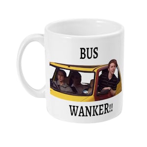 May include: White ceramic mug featuring a yellow car with three people inside. The mug has the text "BUS WANKER!!" in black, with the image of the car and people in the middle of the mug.