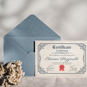 Puede incluir: Un certificado de logro con bordes ornamentados y el nombre "Eleanor Fitzgerald" se muestra junto a un sobre azul. El certificado incluye el texto "Successfully completed the training course from 1st August to 30th October 2022".