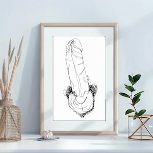 May include: A framed black and white line art print. The artwork depicts a stylized phallus. The print is in a light wood frame and is displayed on a white surface. The background is a white wall.