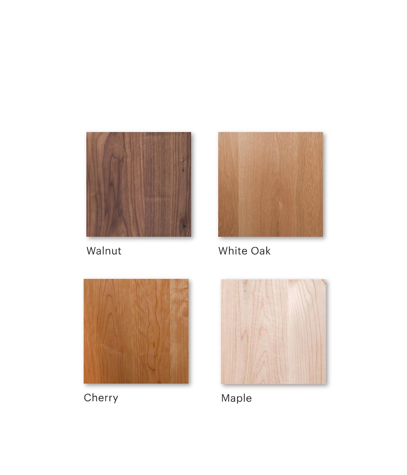May include: Four square wood samples: walnut, white oak, cherry, and maple. Each sample displays the natural grain and color variations of the wood. The names of the wood types are printed below each sample.