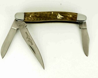 Rough Rider Stockman Knife with hand cut brass sailboat inlay