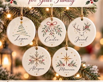 May include: Five round white ceramic Christmas ornaments, each 3 inches in diameter, featuring unique holiday illustrations and personalized names with the year 2026. Designs include a tree, mistletoe, a deer, a snowflake, and a star.
