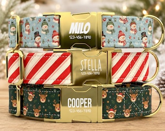 May include: Three pet collars with gold-tone metal buckles. The top collar features a light blue snowman pattern, the middle has red and white diagonal stripes, and the bottom has a dark green reindeer print. Each buckle displays a name and phone number.