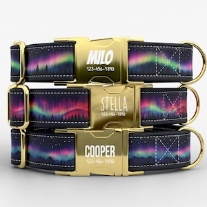 May include: Three personalized dog collars with gold-colored buckles. Each collar features a black background with a colorful aurora borealis design and the name and phone number of the dog. The names are Milo, Stella, and Cooper.