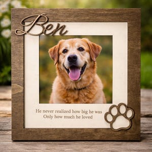 May include: Wooden picture frame with a photo of a golden retriever dog. The frame has the name "Ben" in a cursive font and a paw print cutout. The text below the photo reads: "He never realized how big he was, Only how much he loved."