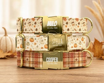 May include: Three dog collars stacked vertically, each featuring a gold-tone metal buckle engraved with a name and phone number. The top collar has a coffee and leaf print, the middle has a pumpkin print, and the bottom has a plaid pattern.