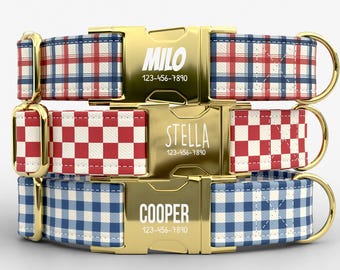 May include: Three personalized dog collars with gold-colored buckles. The collars feature red, white, and blue plaid and checkered patterns. Each buckle is engraved with a name and phone number: MILO, STELLA, and COOPER.