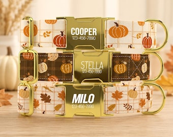May include: Three pet collars with gold-tone metal buckles engraved with names and phone numbers. The top collar is white with orange pumpkins, the middle is dark brown with white pumpkins, and the bottom is white with orange leaves and pumpkins.