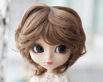 May include: A brown wig with a wavy style for a doll. The wig is styled with a side part and has a layered look.