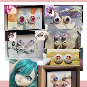 May include: A collection of round doll eyes in various colors and designs, including pink, purple, yellow, red, and blue iris patterns. The eyes are displayed on printed cards, some featuring anime-style character illustrations and text.