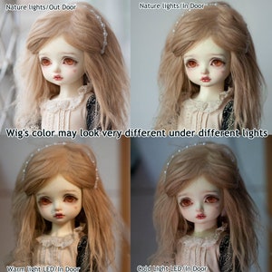 May include: Four images of a doll with long, light brown hair wearing a white dress. The images show the doll under different lighting conditions: natural light outdoors, natural light indoors, warm light LED indoors, and cold light LED indoors. The text "Wig's color may look very different under different lights" is displayed below the top two images.