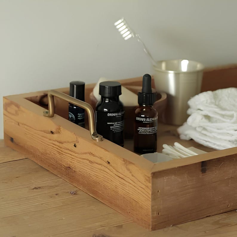 Close-up view of a handcrafted solid brass pull handle held in hand, showing texture and mounting hole.