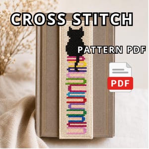 May include: A cross-stitch bookmark featuring a black cat silhouette atop a stack of colorful books. The bookmark is made of beige fabric and is displayed on a closed book. Text on the image reads "CROSS STITCH" and "PATTERN PDF". A PDF icon is also visible.