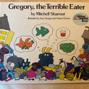 May include: A vintage children's book cover titled "Gregory, the Terrible Eater" by Mitchell Sharmat. The cover features a whimsical illustration of a goat and thought bubbles with food items. The book has a "Reading Rainbow Book" logo.
