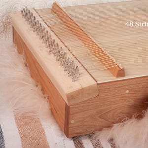 May include: A rustic wooden sign with the text "Welcome to our home" in white lettering. The sign features a distressed finish and a simple, inviting design, perfect for front door decor.