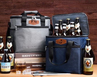 May include: A grey cooler bag with an RM leather patch and a navy blue cooler bag with a James leather patch, both featuring black handles and zips. Several brown glass beer bottles with labels including Vedett and Franziskaner are present.
