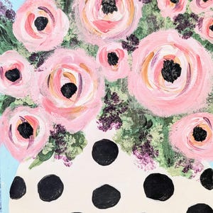 May include: An acrylic painting of a bouquet of pink roses with black centers in a white vase with black polka dots. The background is light blue, and the flowers have green and purple accents.
