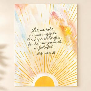 May include: A rectangular print featuring a yellow sun at the bottom with radiating golden lines extending upward. The background has soft watercolor washes of pink, blue, and yellow. The text reads: Let us hold unswervingly to the hope we profess, for he who promised is faithful. Hebrews 10:23.