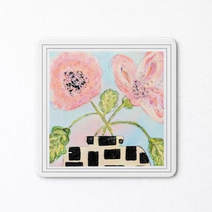 May include: A square sticker featuring a watercolor painting of pink flowers in a black and white patterned vase. The background is a light blue with green leaves and stems.