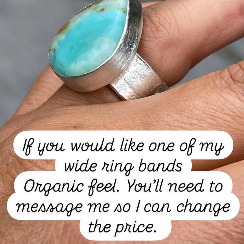 May include: A silver ring with a large, teardrop-shaped turquoise stone. The ring has a wide band with a textured finish. The text on the image says, "If you would like one of my wide ring bands Organic feel."