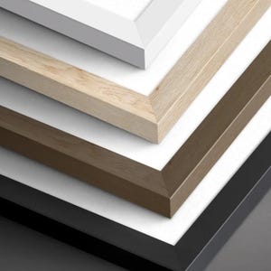 May include: A stack of four rectangular picture frames shown in a corner view. The frames are finished in white, light wood grain, medium brown wood grain, and solid black. Each frame contains a white mat board. The text Frame Options is visible.