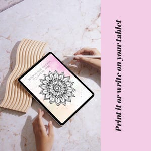 May include: A digital tablet displaying a mindfulness mandala coloring page. The page features a detailed black and white floral design with the text "MINDFULNESS MANDALA COLORING PAGE". A wooden decorative piece is on the left. The text "Print it or write on your tablet" is on the right.