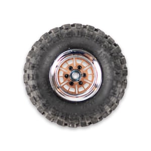 以下が含まれることがあります： 銅色のホイールと銀色のリムが付いた黒いゴムタイヤのクローズアップ。ホイールの中央には小さな黒いボルトが並んでいます。タイヤは、オフロードでの使用に適した頑丈なトレッドパターンを持っています。