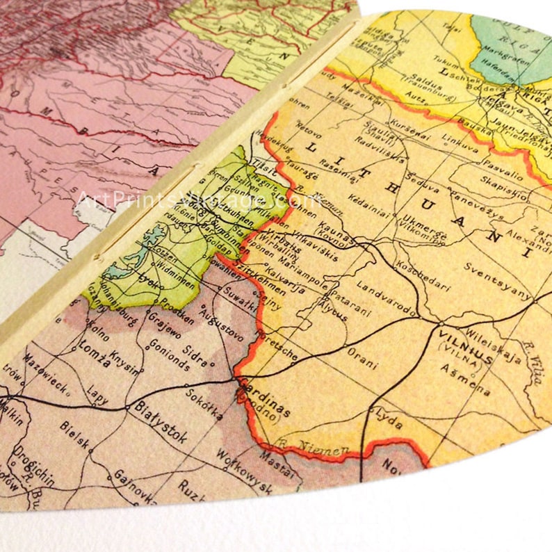 May include: A vintage map of Lithuania, Latvia, and parts of Poland. The map is printed on yellowed paper and features a faded red, green, and blue color scheme. The map includes city names and borders.