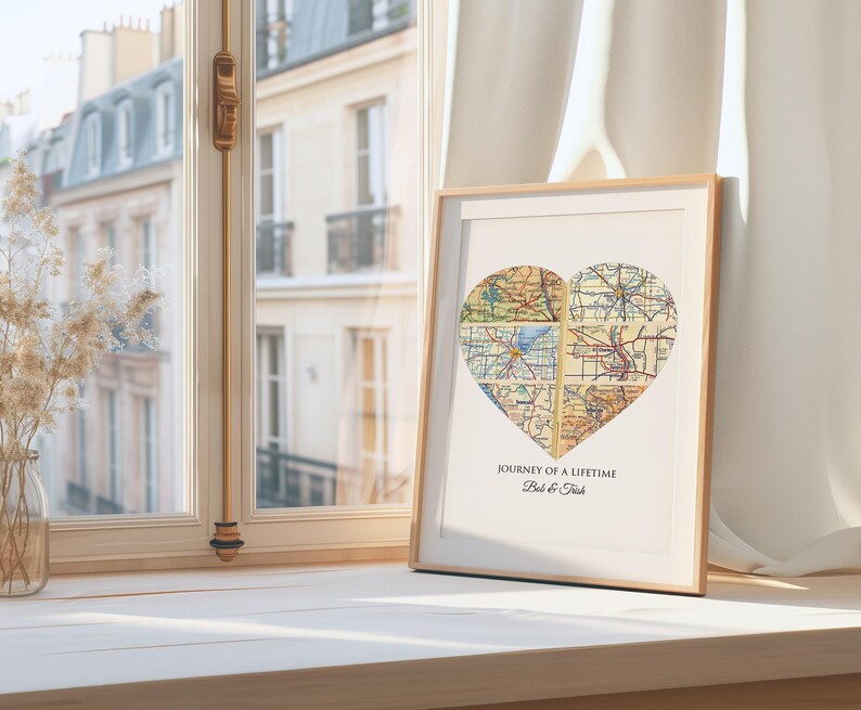 A custom map art displaying maps of the couples cities and meaningful locations including where they first kissed or met, tied the knot, live and other sentimental places. The heart shape wall art also shows a personalized caption with 'Our journey of a lifetime' and the couples names